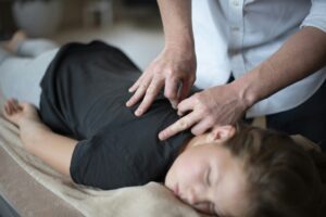 a woman getting a back massage from a massager